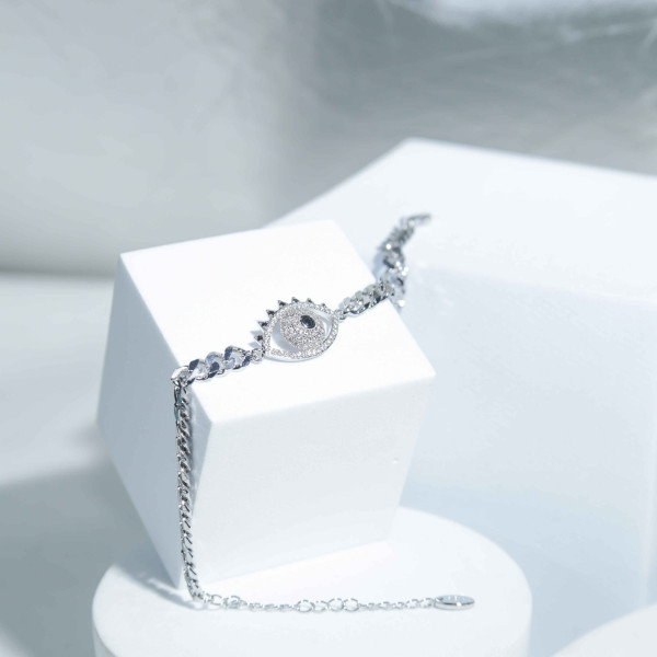 Silver Color Bracelet with Eye Shape Adorned with Stones Like Diamonds